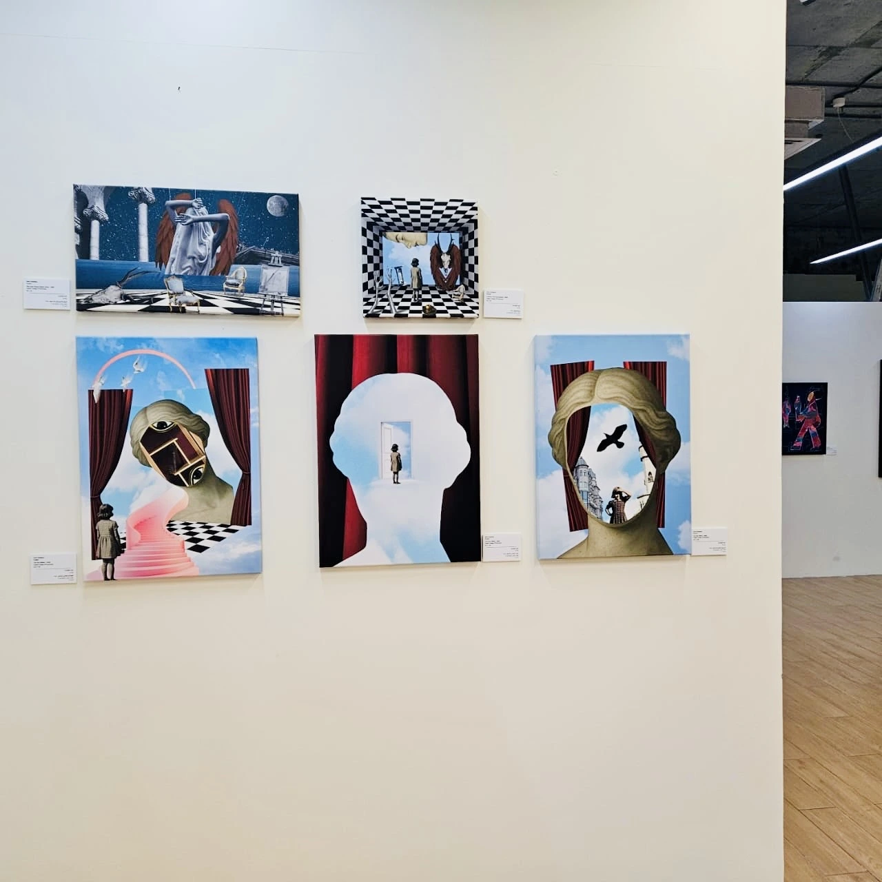 Dislocated Dreams collages displayed on a gallery wall in Dubai